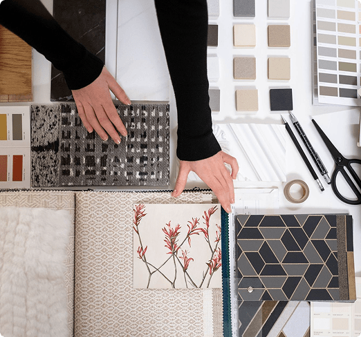 Interior designer reviewing fabric, tile and color samples for a client project